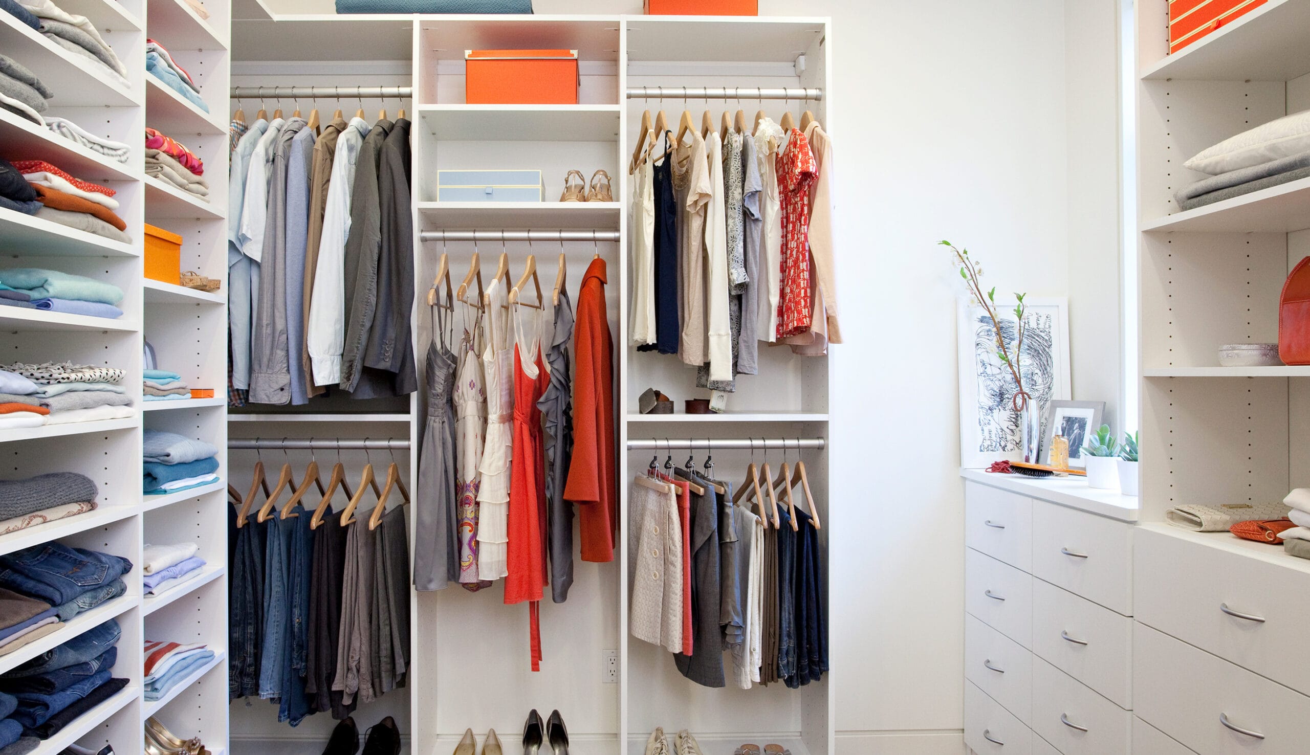 After custom closet redesign in a white finish with custom cabinets by California Closets