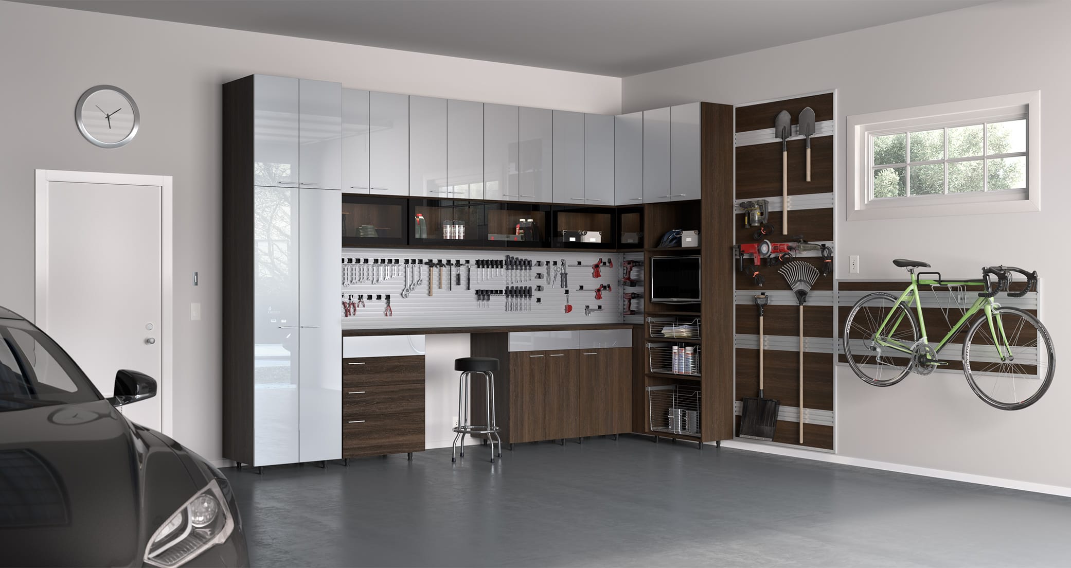 Workbench surrouned by garage storage cabinets in a dark finish by California Closets