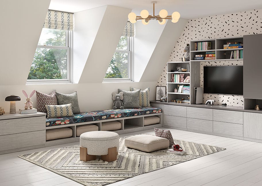 Custom playroom converted from an unused attic space with toy storaage media center, cubbies, and library shelves for kids created by California Closets