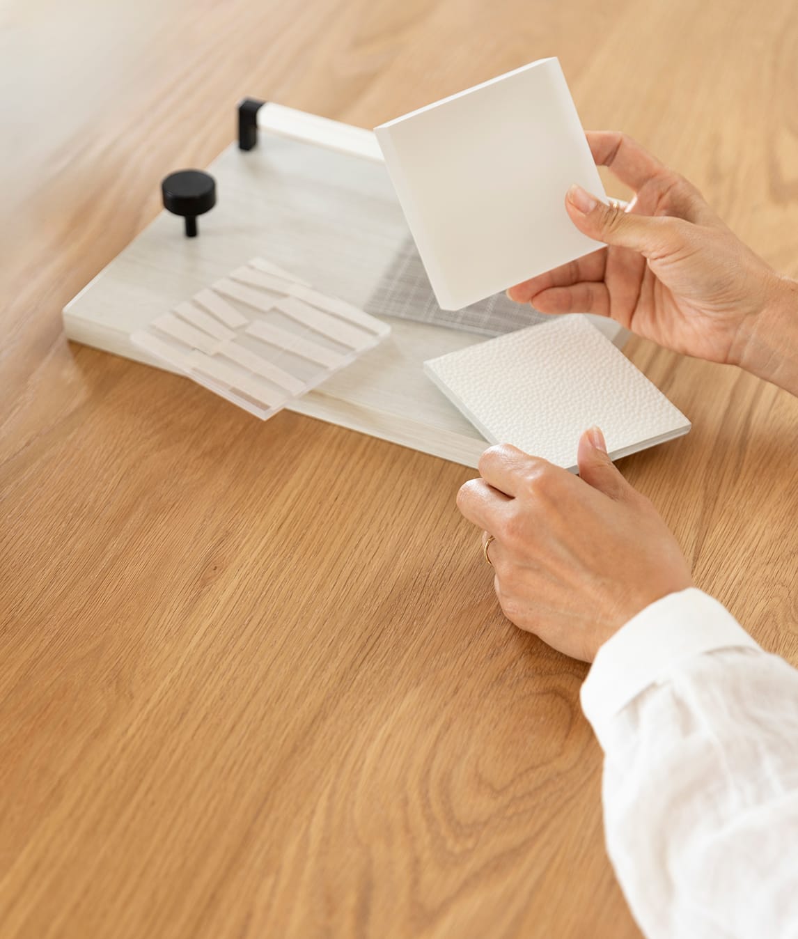 Designer shows samples of finishes and materials during design consultation at a California Closets showroom