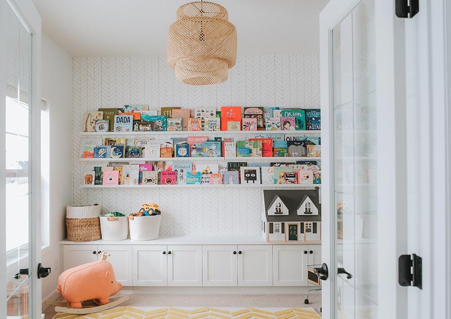 Kids playroom with bookshelves, drawers, shelving by California Closets