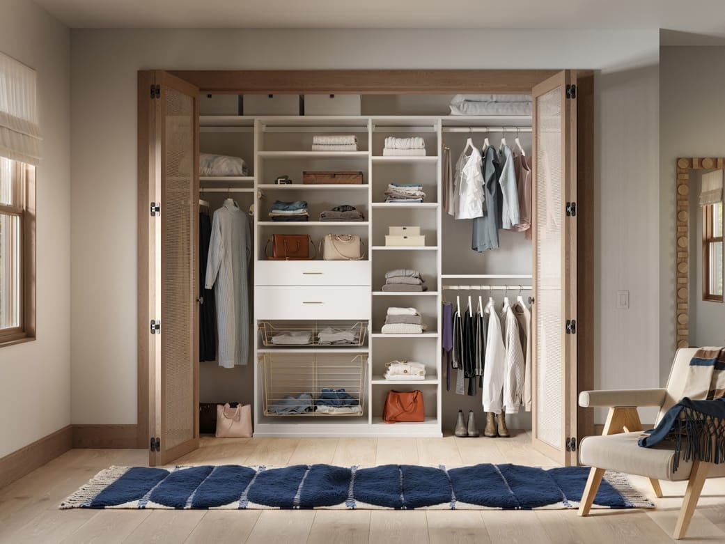 Drawers designed open shelving in reach in closet by California Closets