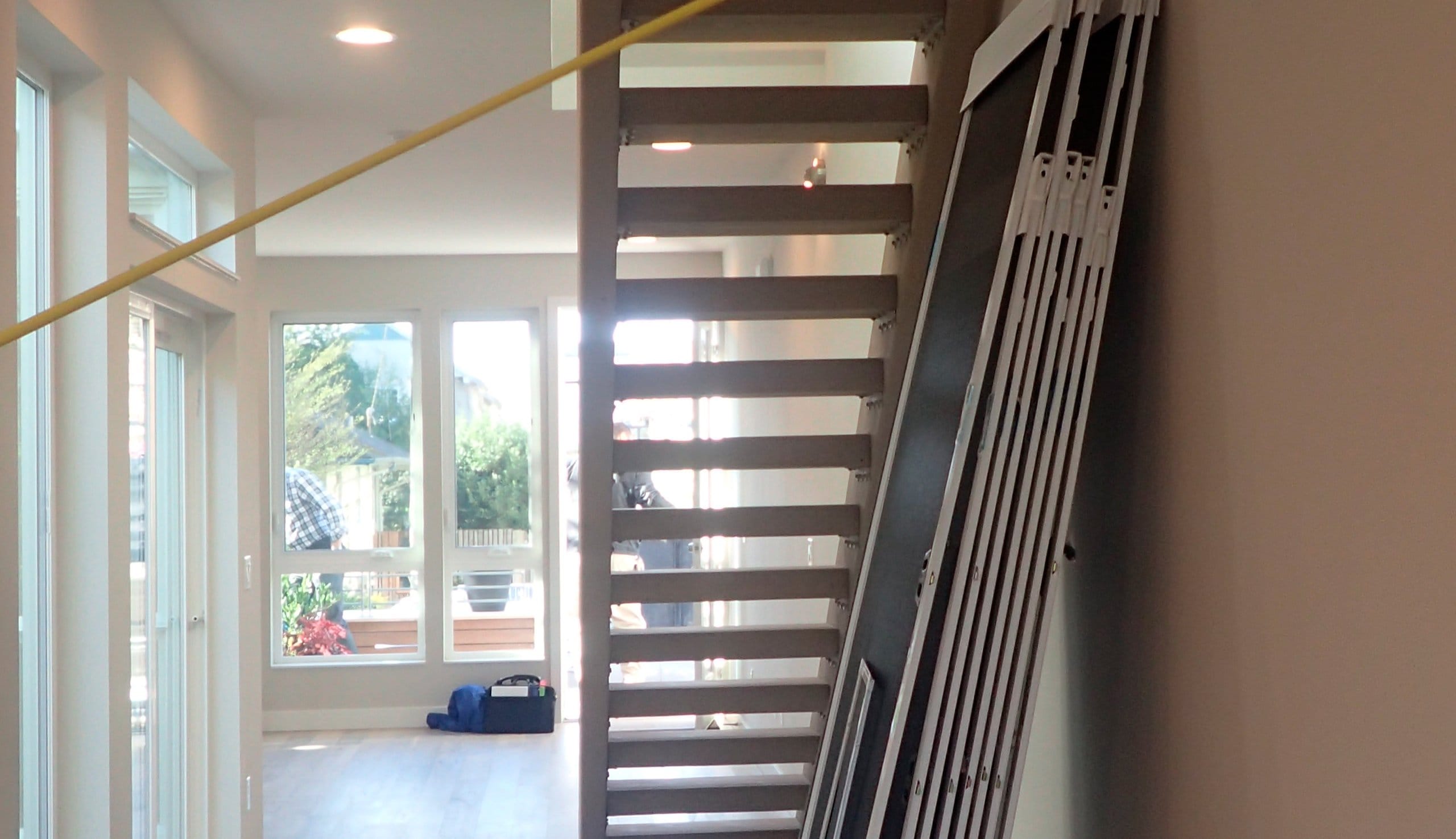 Before space for a new build custom pantry under the stairs build by California Closets