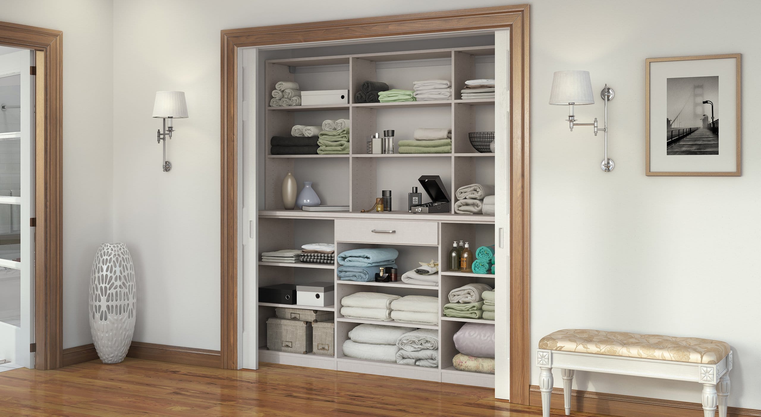 Hall linen reach in closet shelving and drawer organizer by California Closets