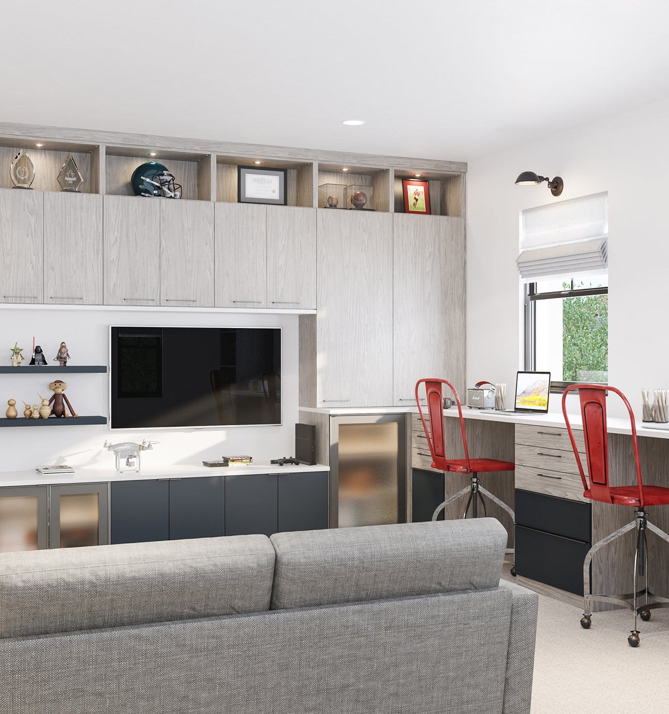 Family room workspace with entertainment center, light wood cabinetry, shelving, and custom lighting by California Closets