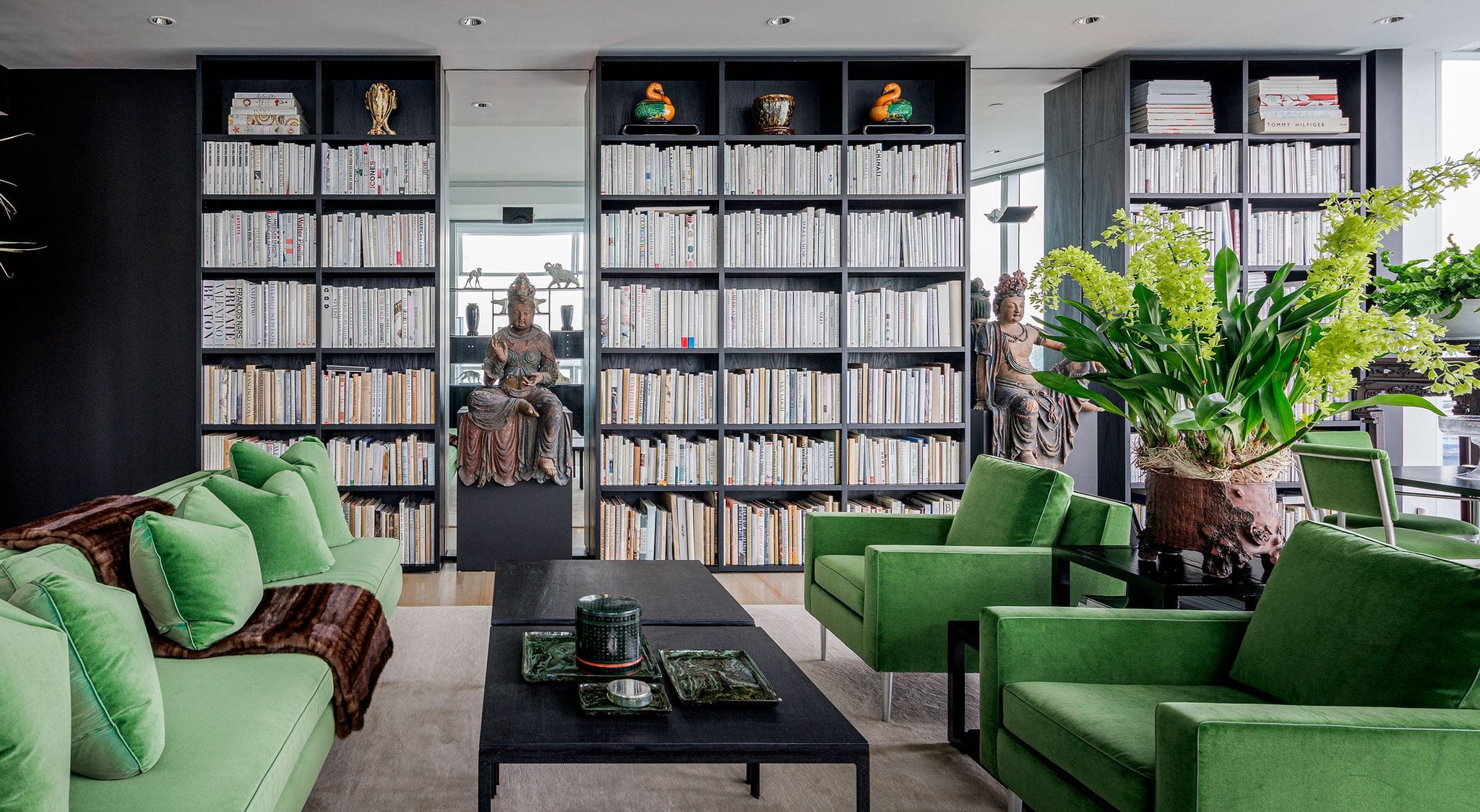 Custom bookcases built from black wood finish, floor to ceiling design for home library by California Closets